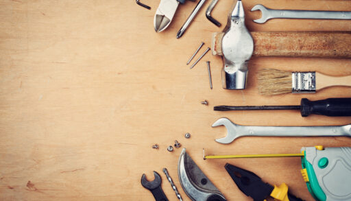 A collection of tools against a wood background