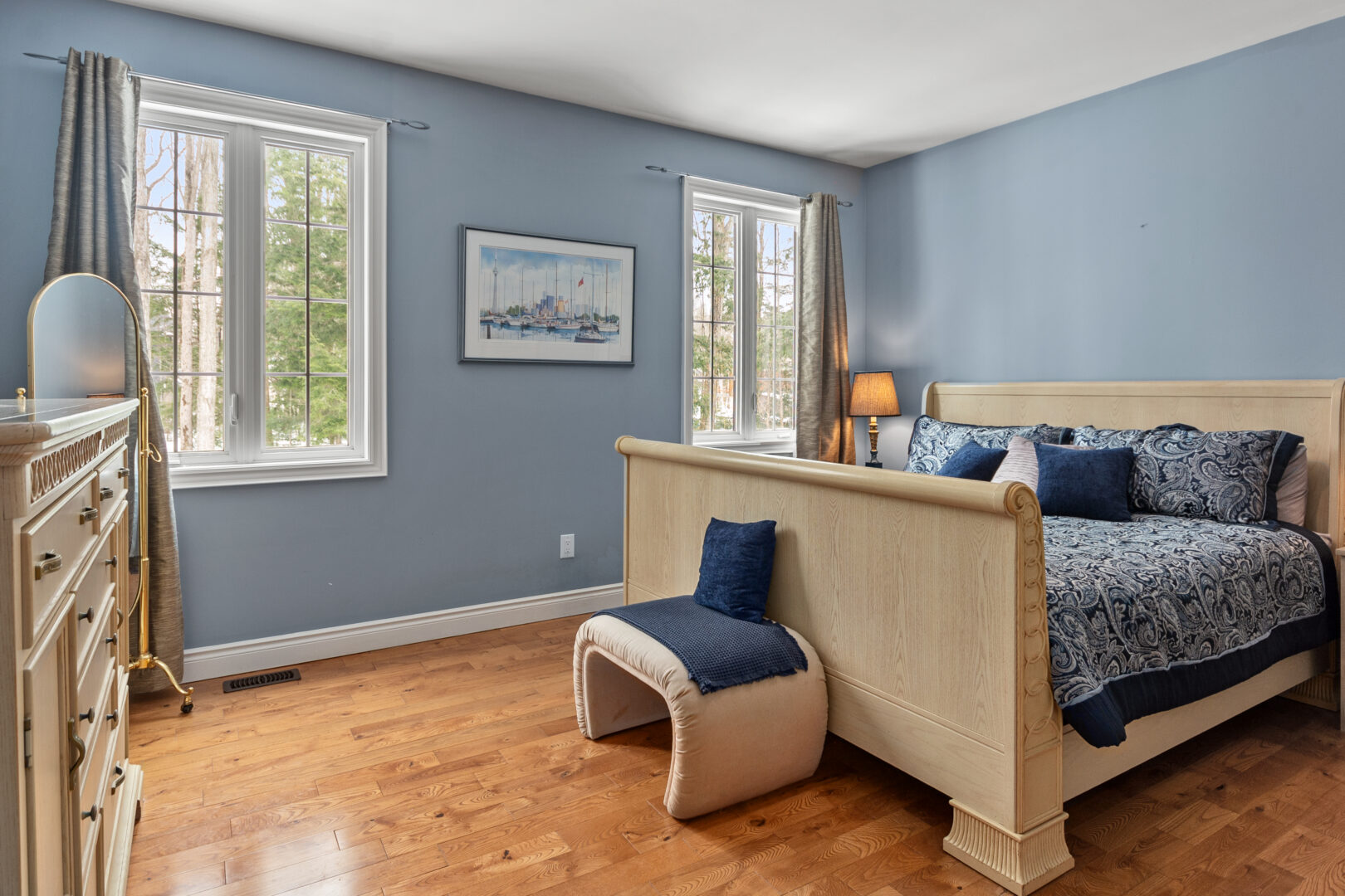 A sled-style bed in a light blue bedroom