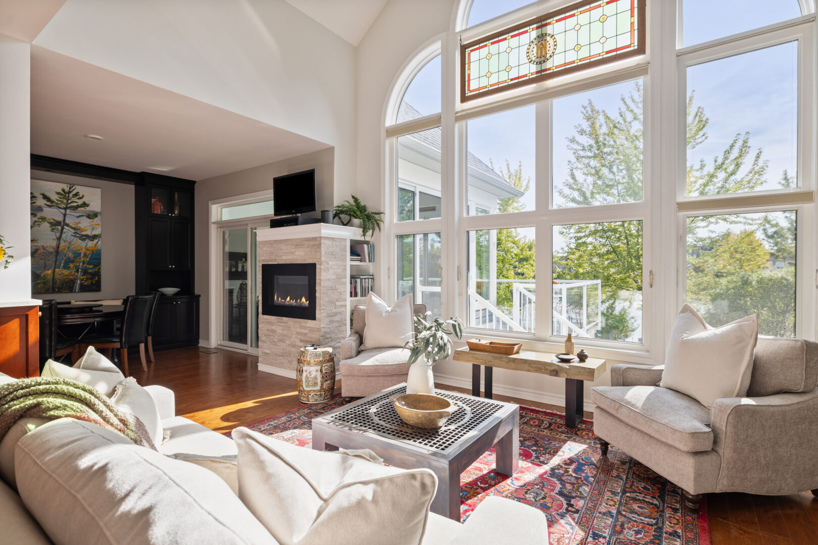 A spacious living area with cathedral windows and a white sitting area