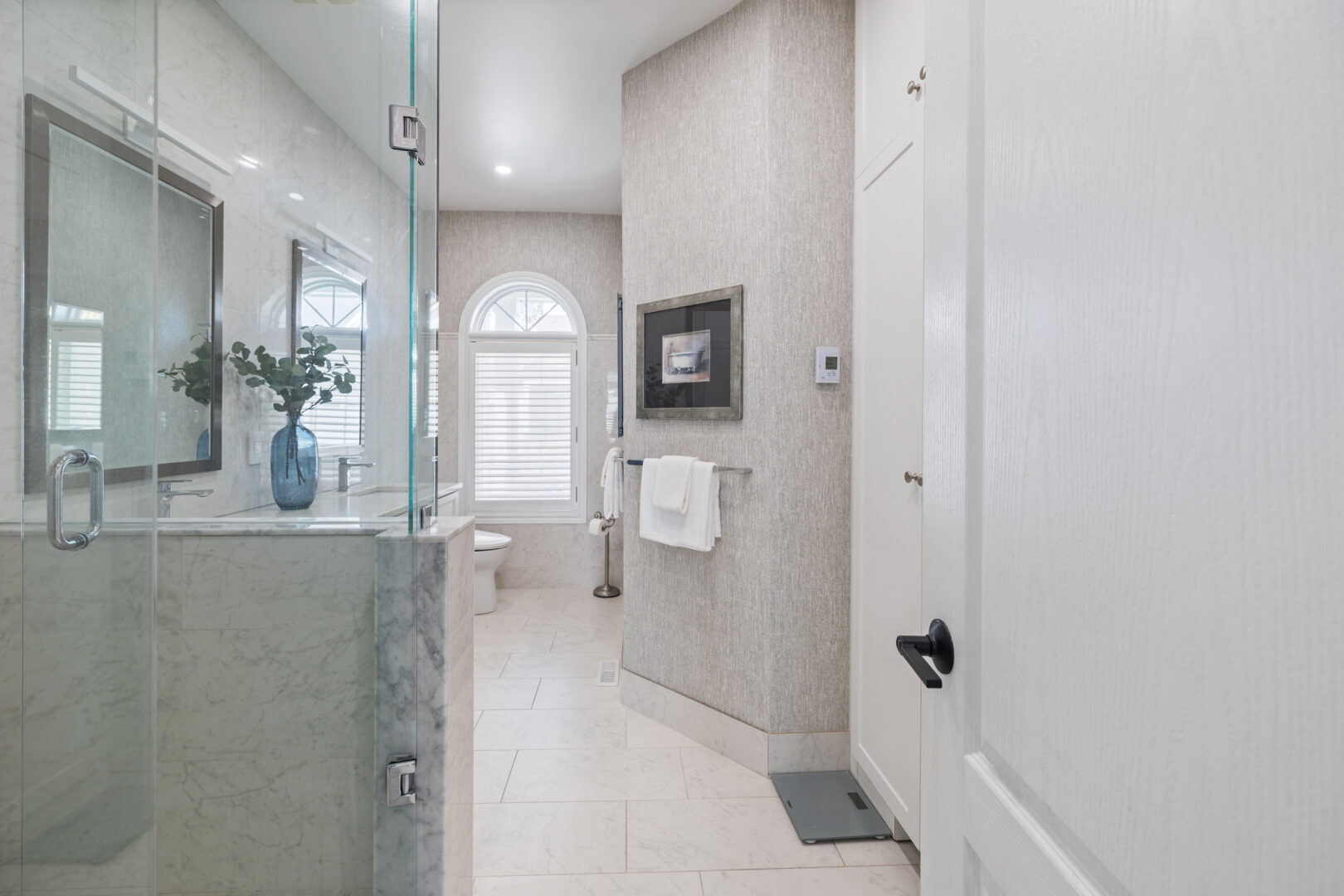 A light grey bathroom with a walk-in shower