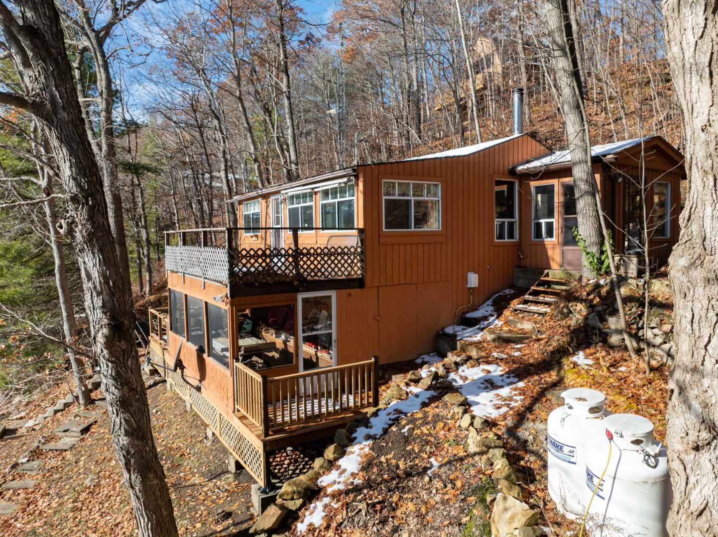An orange-toned cottage with a double deck
