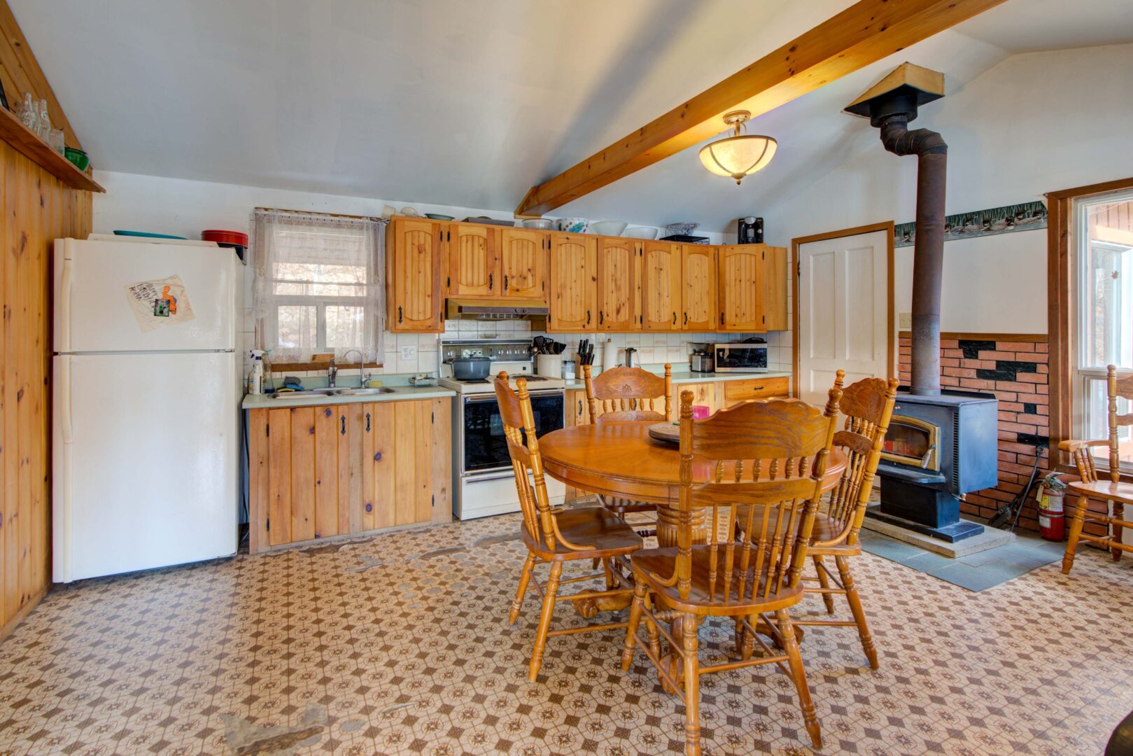 A green pool table in a bright rec room with huge glass windows
