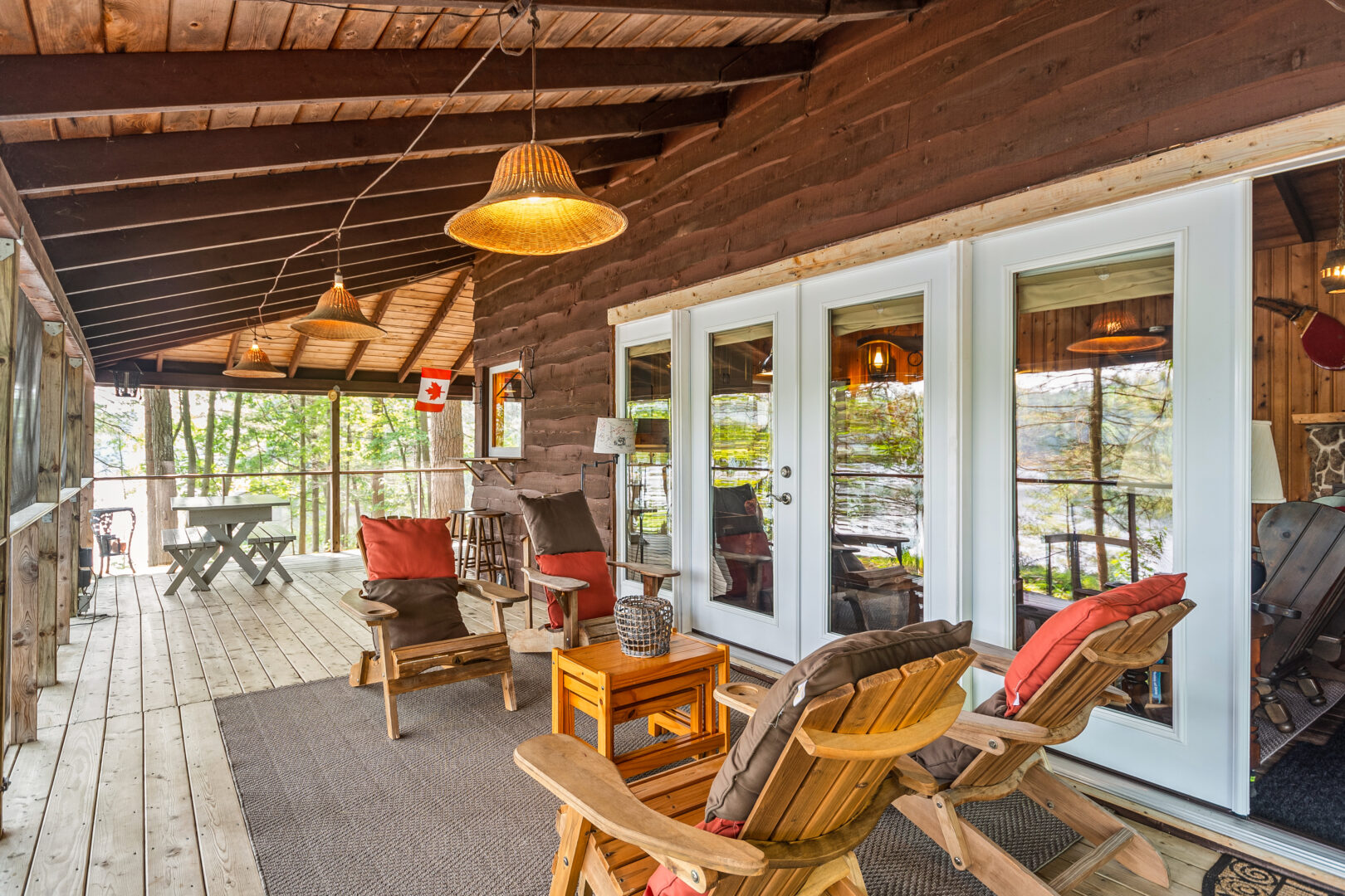 Wood Muskoka chairs face each other on a wood deck
