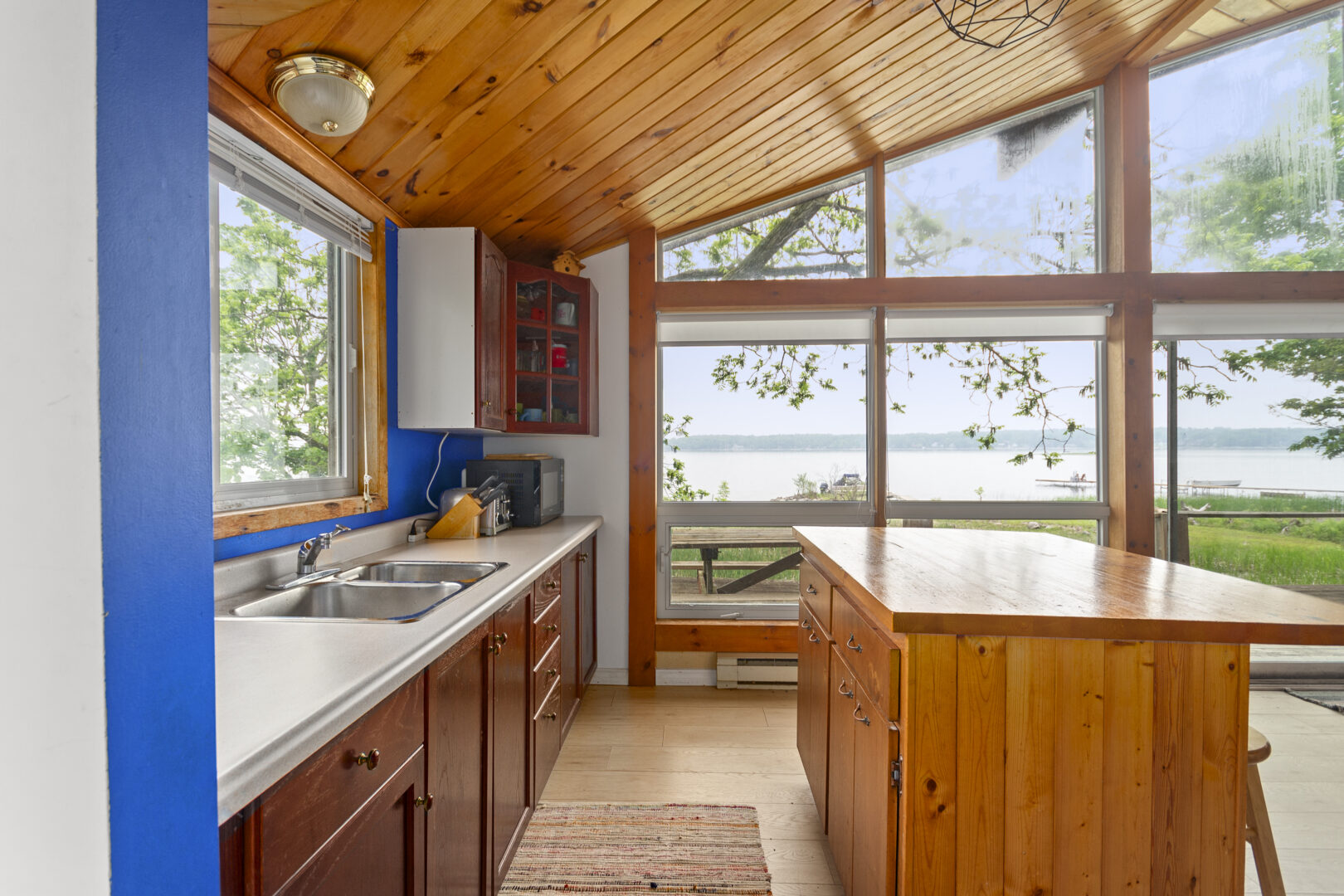 A kitchen with wood cabinets and a wood ceiling