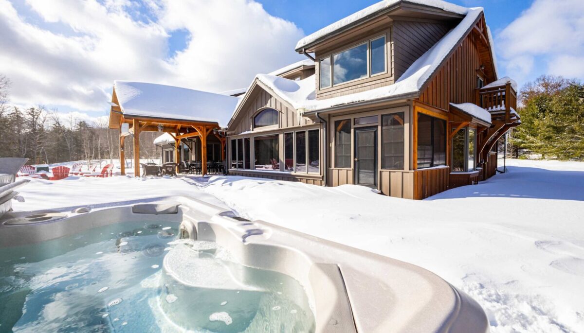 A bubbling hot tub in a snowy backyard