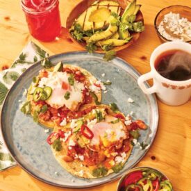 Huevos Rancheros with Sausage and Grilled Avocado on a table