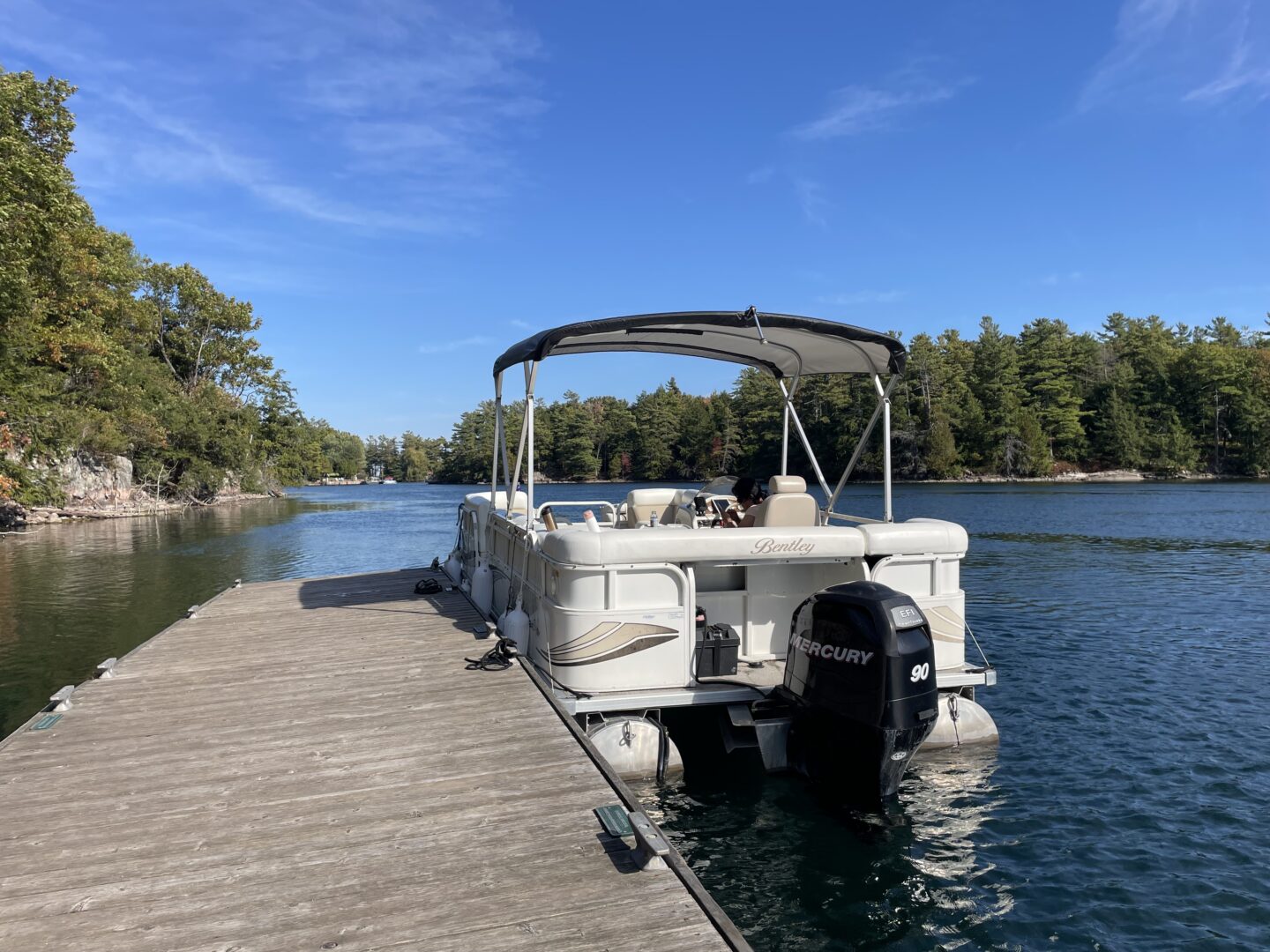 A white boat parked on the side of a dock