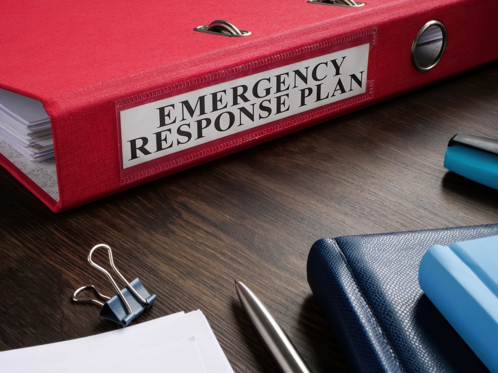 A binder and supplies that says Emergency Response Plan