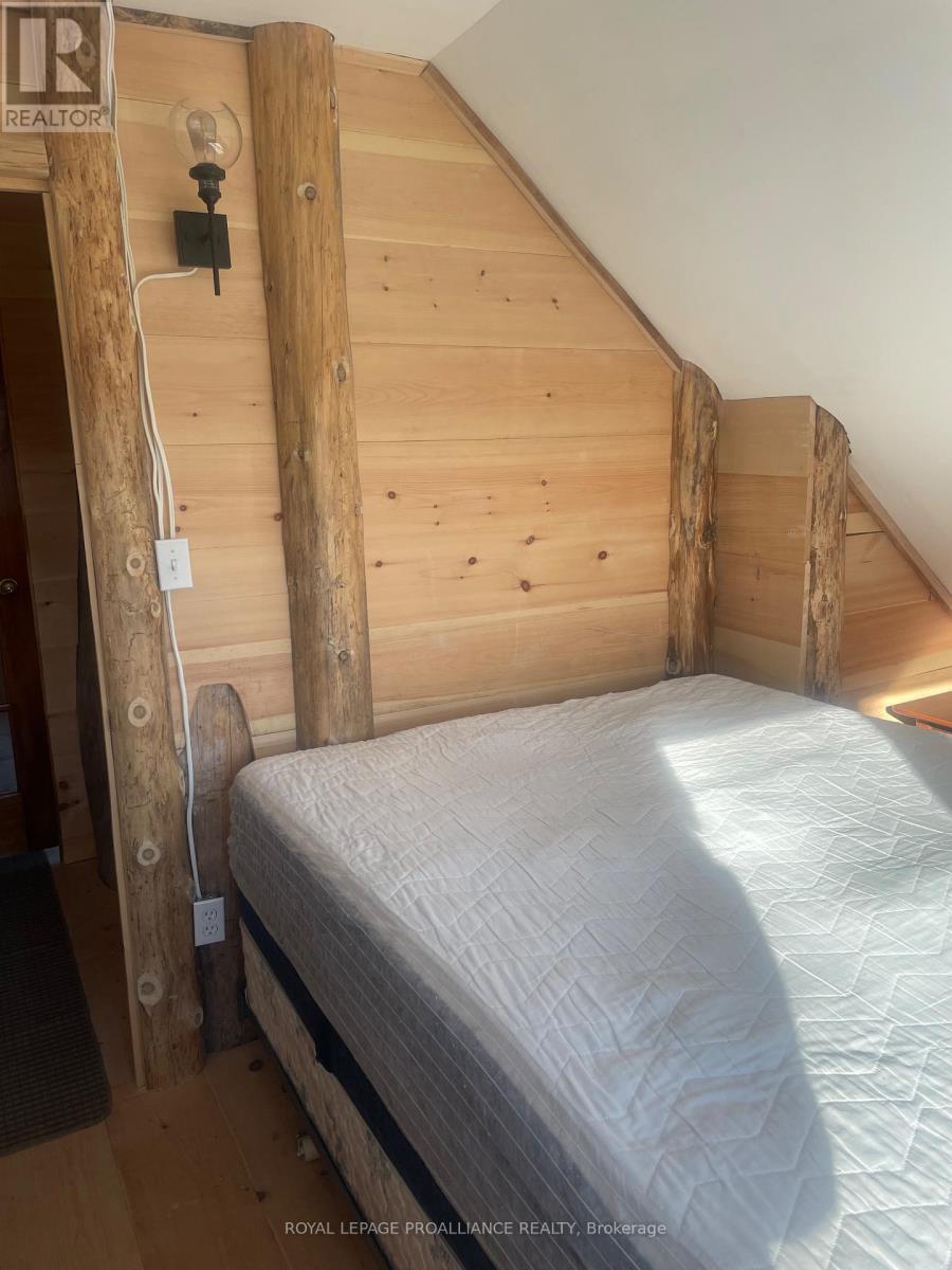 A white mattress in a wood bedroom