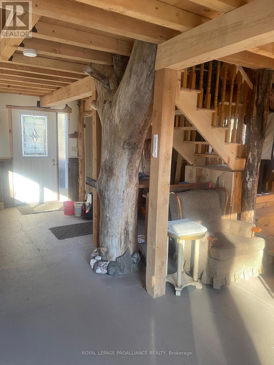 A tree stump is growing into a wood staircse